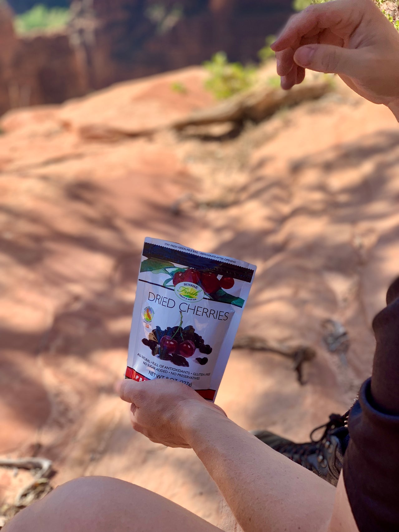 Alt-text: Sunrise Fresh dried cherries snack bag on a trail